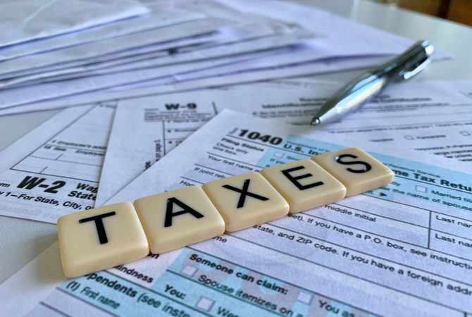 low-angle-of-letter-tiles-with-the-word-taxes-on-a-2022-08-01-03-13-46-utc